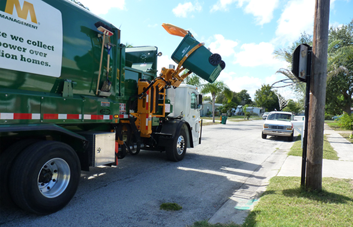 Recycling collection truck picking up a curbside cart