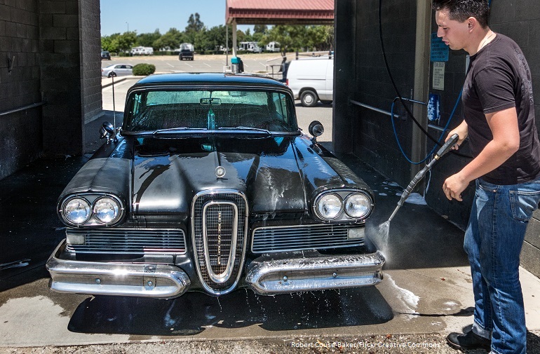 Image of man washing car at a commercial car wash. Photo by Robert Couse-Baker, Flickr Creative Commons.
