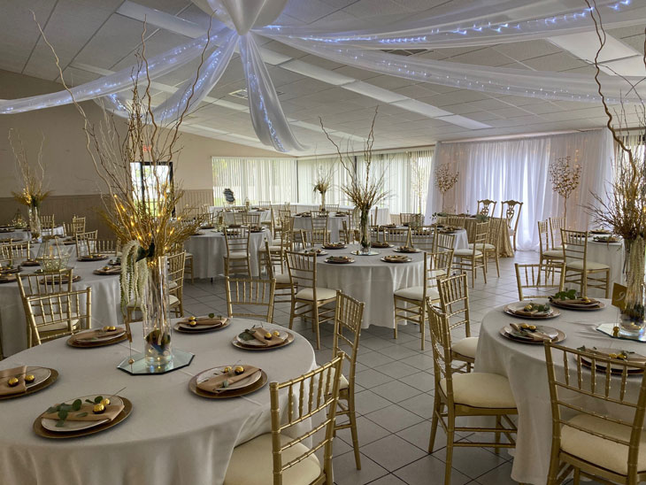 Interior of Front Street Civic Center set up for a formal reception with decorations and formal table settings.