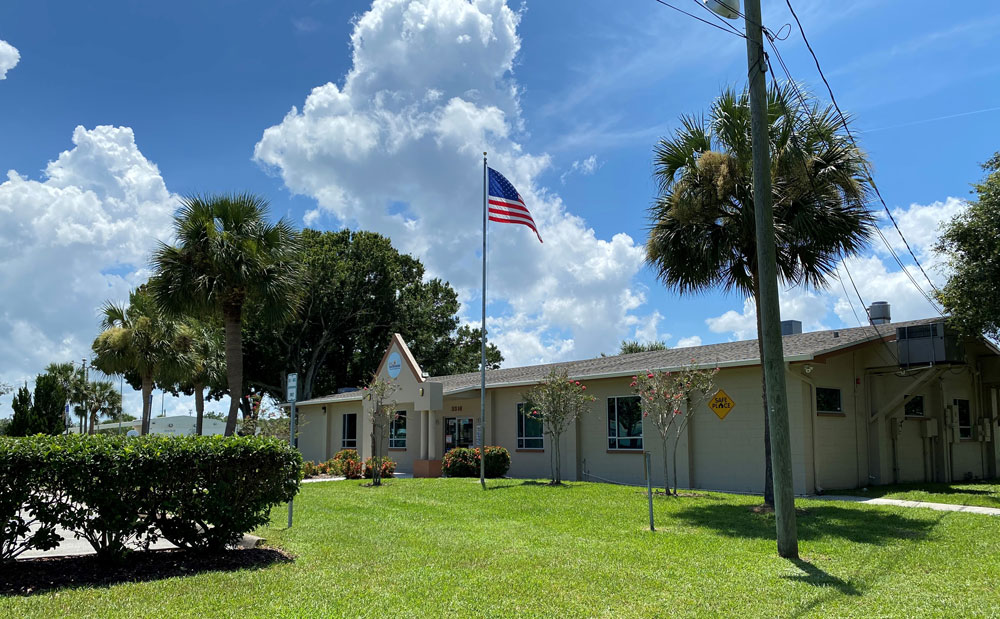 Side view of Lipscomb Community Center with trees and grass