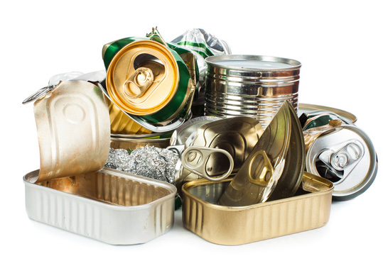 An assortment of used cans and tins from beverages, pet food, and other