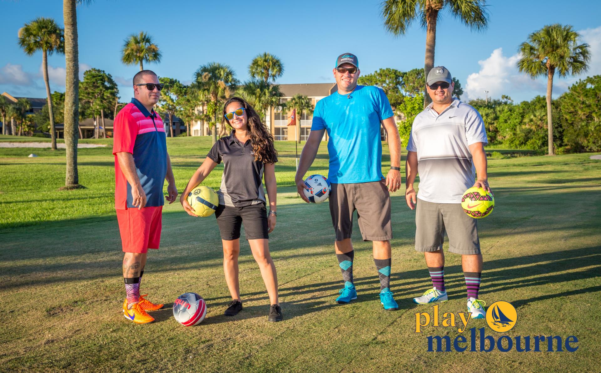 Four footgolf players holding soccer balls with Play Melbourne logo in corner