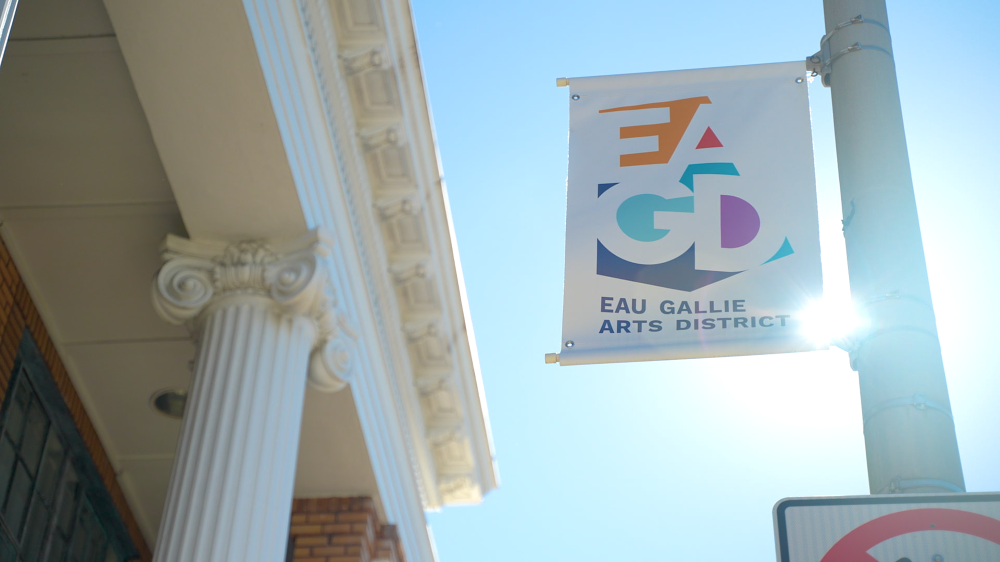 View of EGAD Eau Galie Arts District street pole banner next to a building