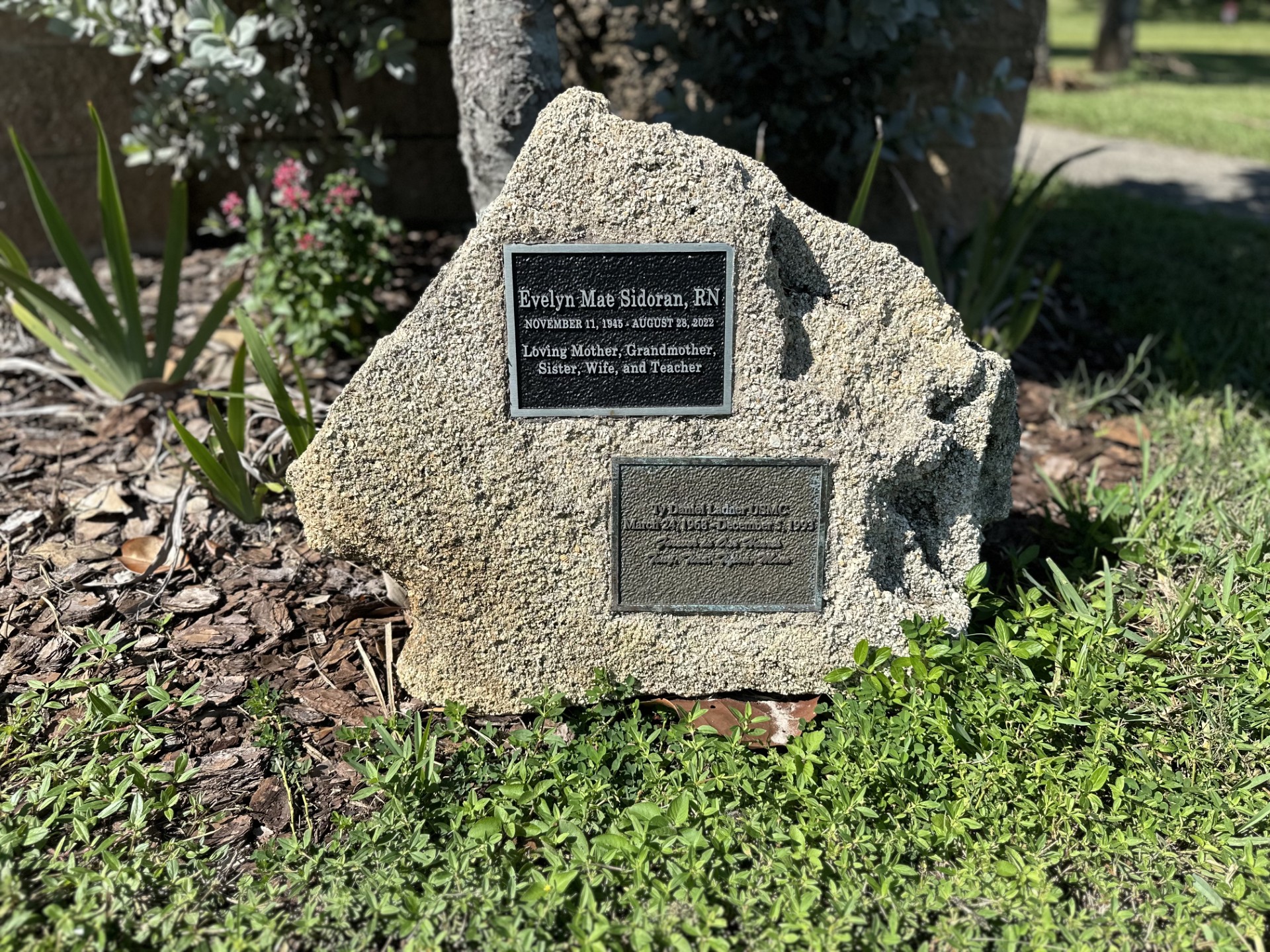 Close up of two memorial plaques on a coquina stone