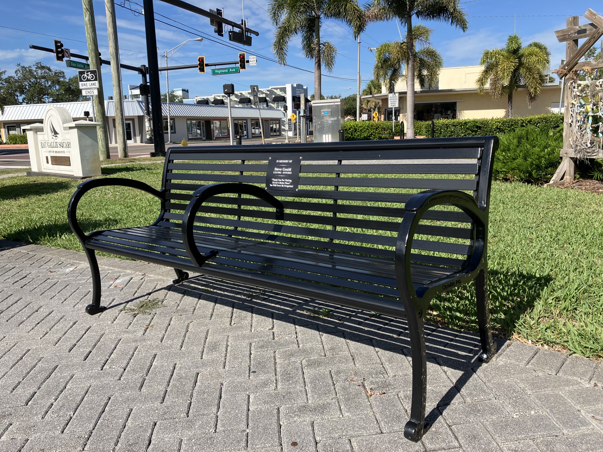 Memorial plaque on a metal bench at Eau Gallie Square