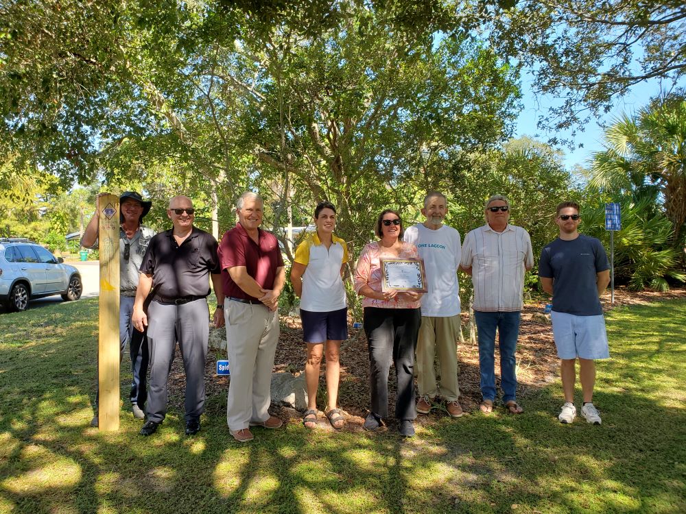 BEEB members standing outside under a tree at a past Gems Award presentation